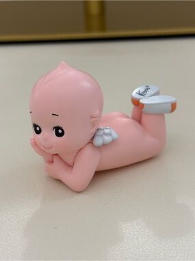 Kewpie laying down doll